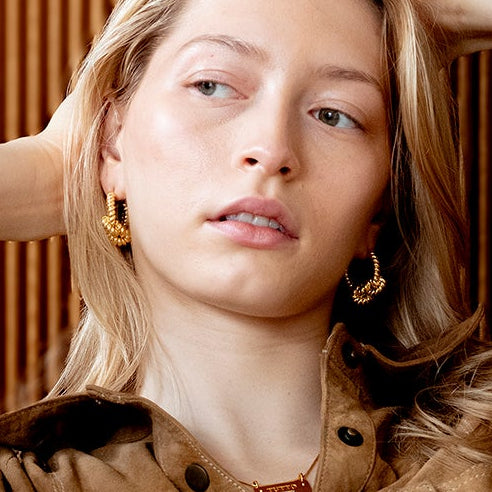 KNOT HOOP Gold worn as graphic statement earrings